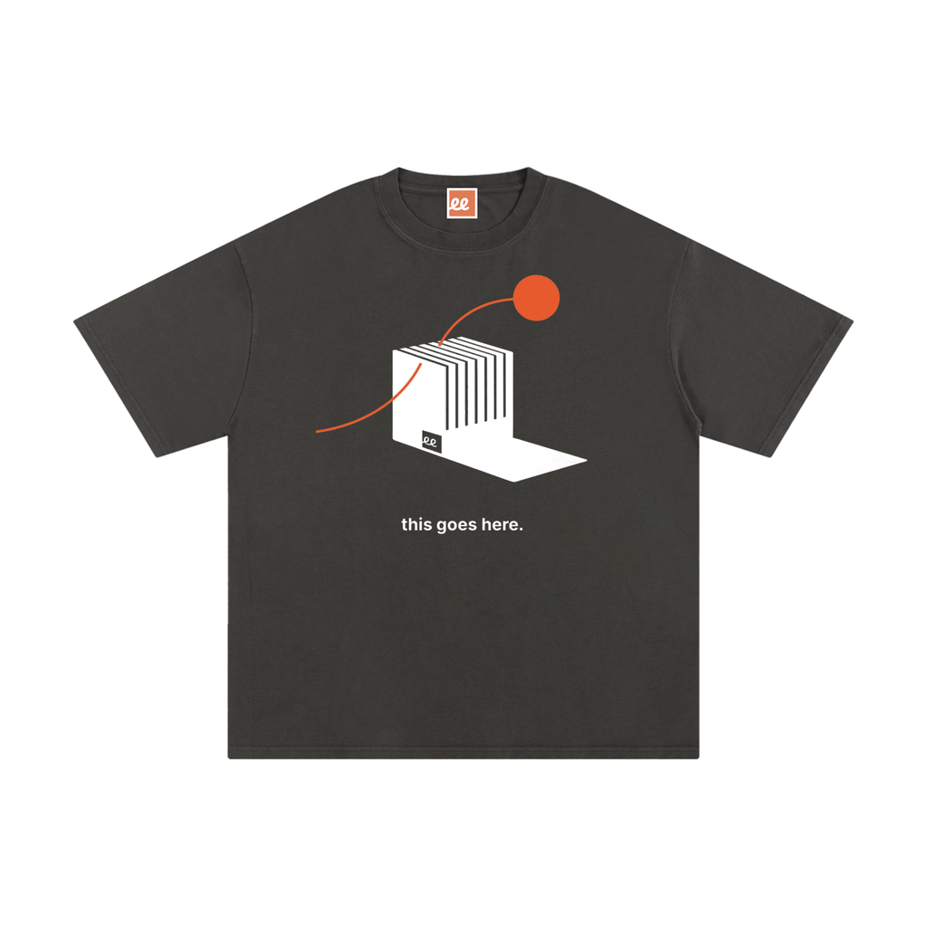 This Goes Here Tee in Dark Gray, front: Energy Router wired to a Red Ochre circle